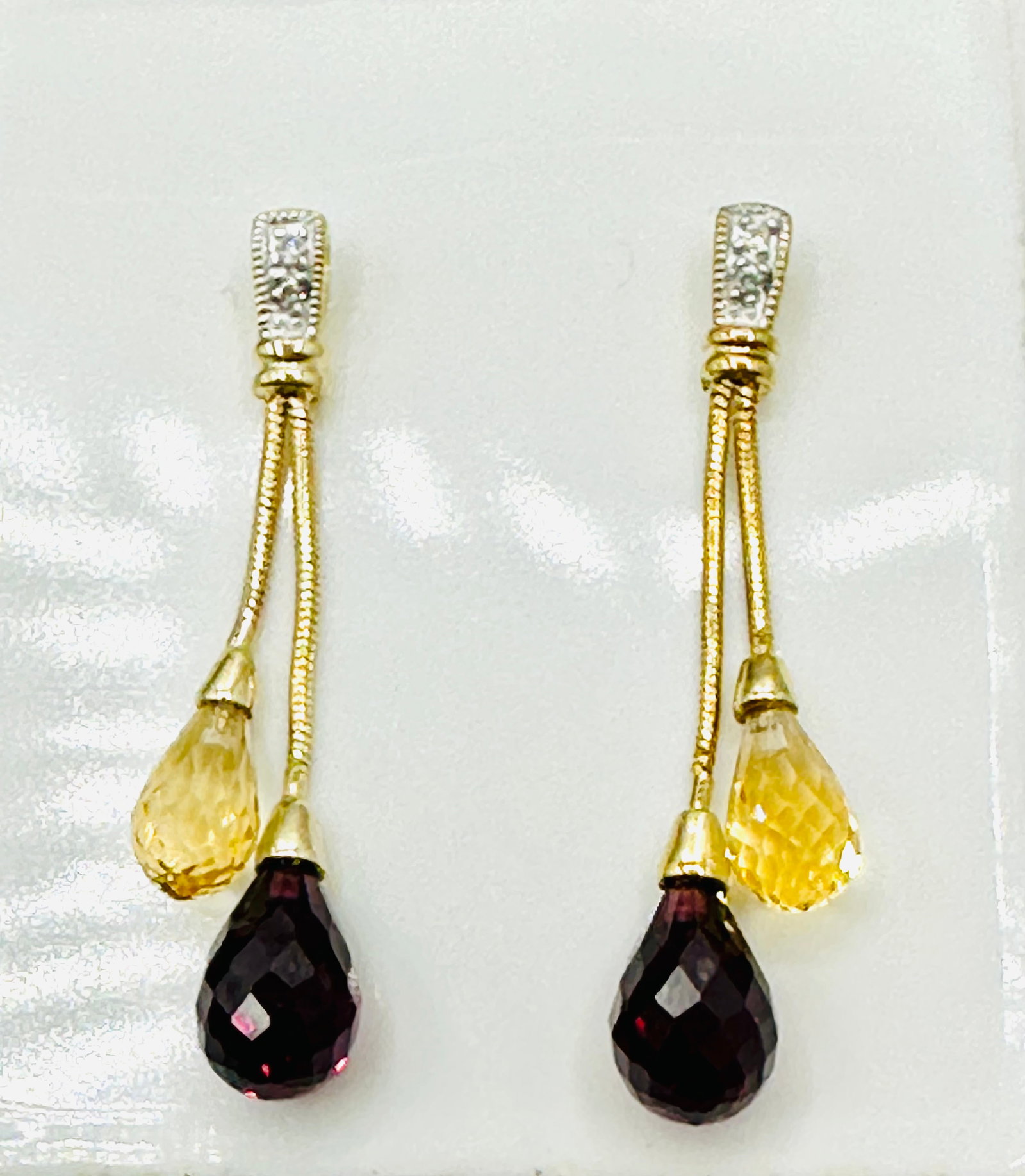 14KT Yellow Gold,Pair of Citrine,Garnet and Diamond Drop Earrings # 2769: # 2769 14KT Yellow Gold,Pair of Citrine,Garnet and Diamond Drop Earrings 4 pieces diamond 2 pieces citrine 2 pieces garnet Post back Earrings Weight: 2.5 grams(t.w.) Approx. Drop: 1-1/4â€?