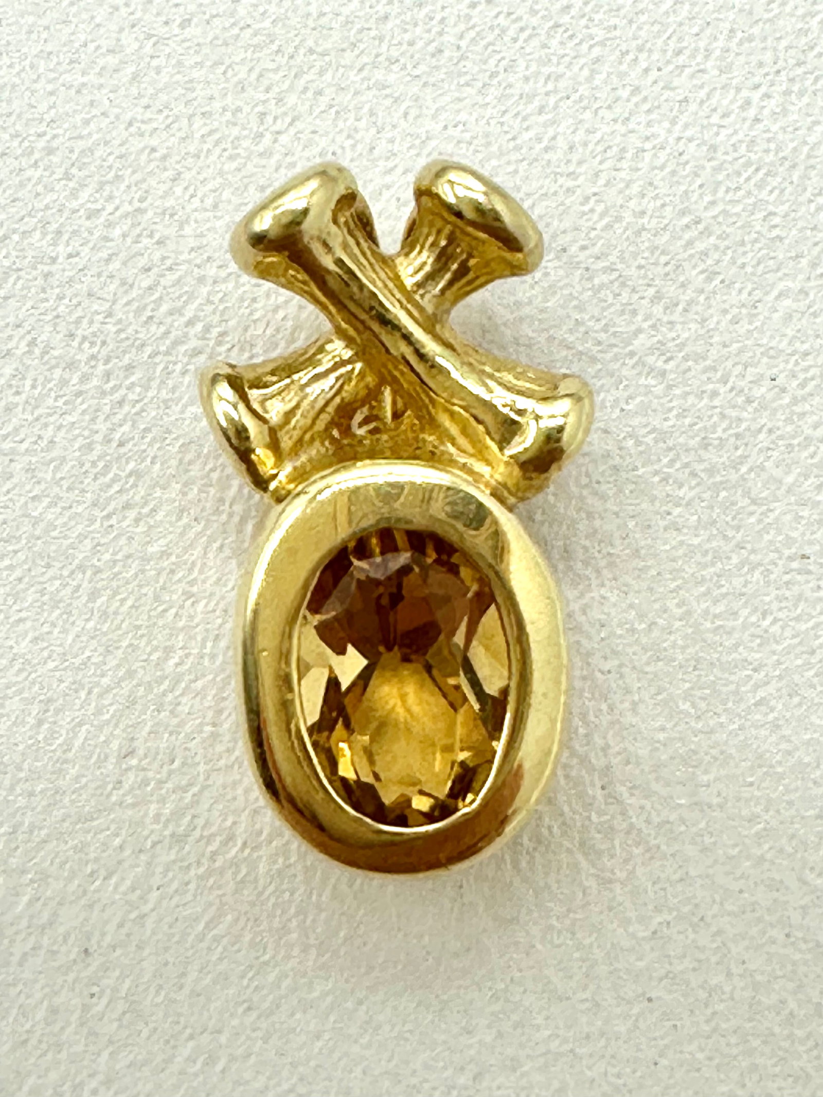 14KT Yellow Gold X-O Pendant # 2774: # 2774 14KT Yellow Gold X-O Pendant 1 piece oval yellow topaz Pendant Weight: 1.40 grams (t.w.) Pendant size: 15 mm X 7.50 mm