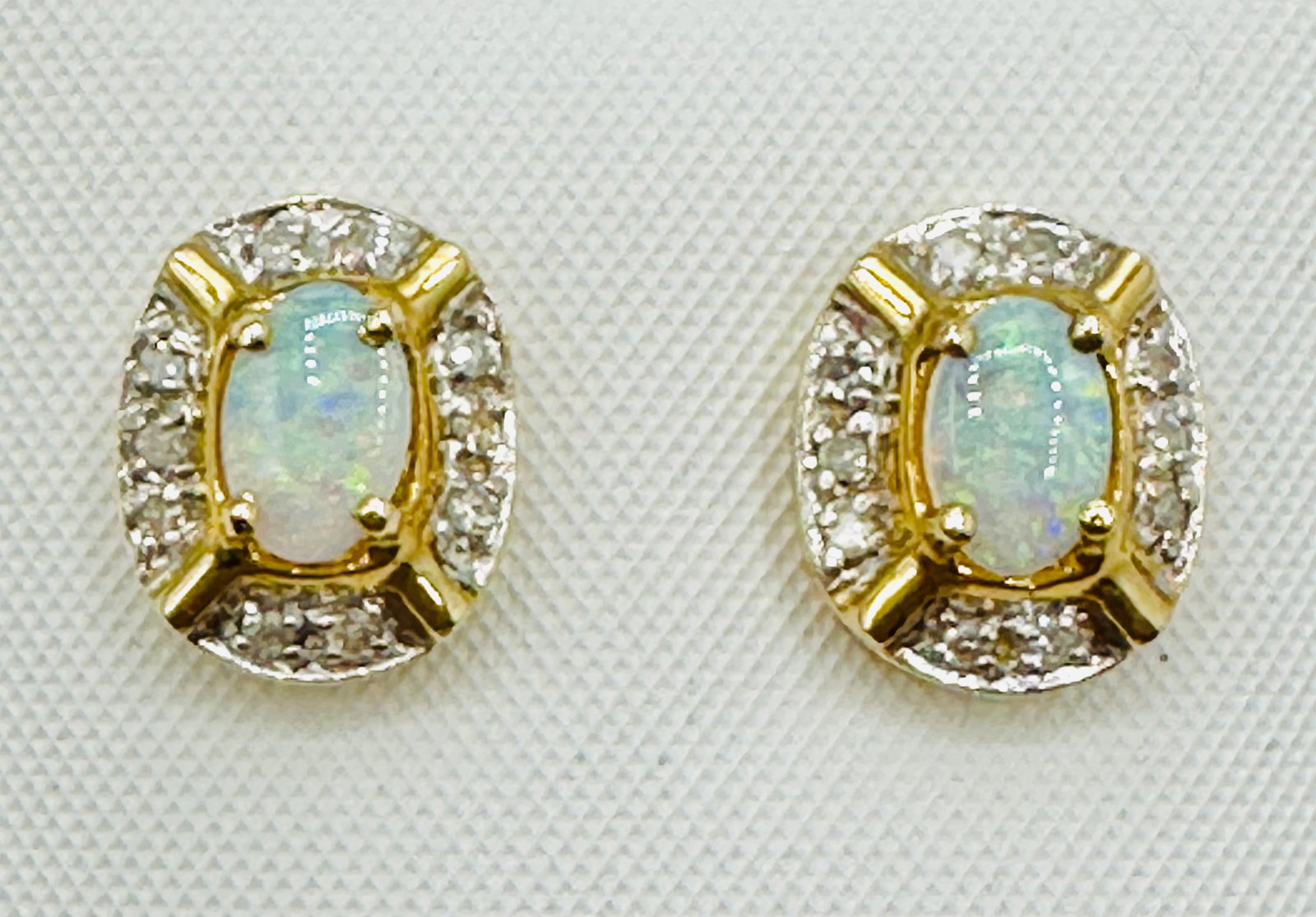 14KT Yellow Gold,Pair of Natural Diamond and Opal Earrings # 2776: # 2776 14KT Yellow Gold,Pair of Natural Diamond and Opal Earrings 20 pieces diamond 0.12 carat (t.w.) 2 pieces oval opals Post back Earrings Weight: 2.3 grams(t.w.) Earrings size: 11 mm x 9 mm
