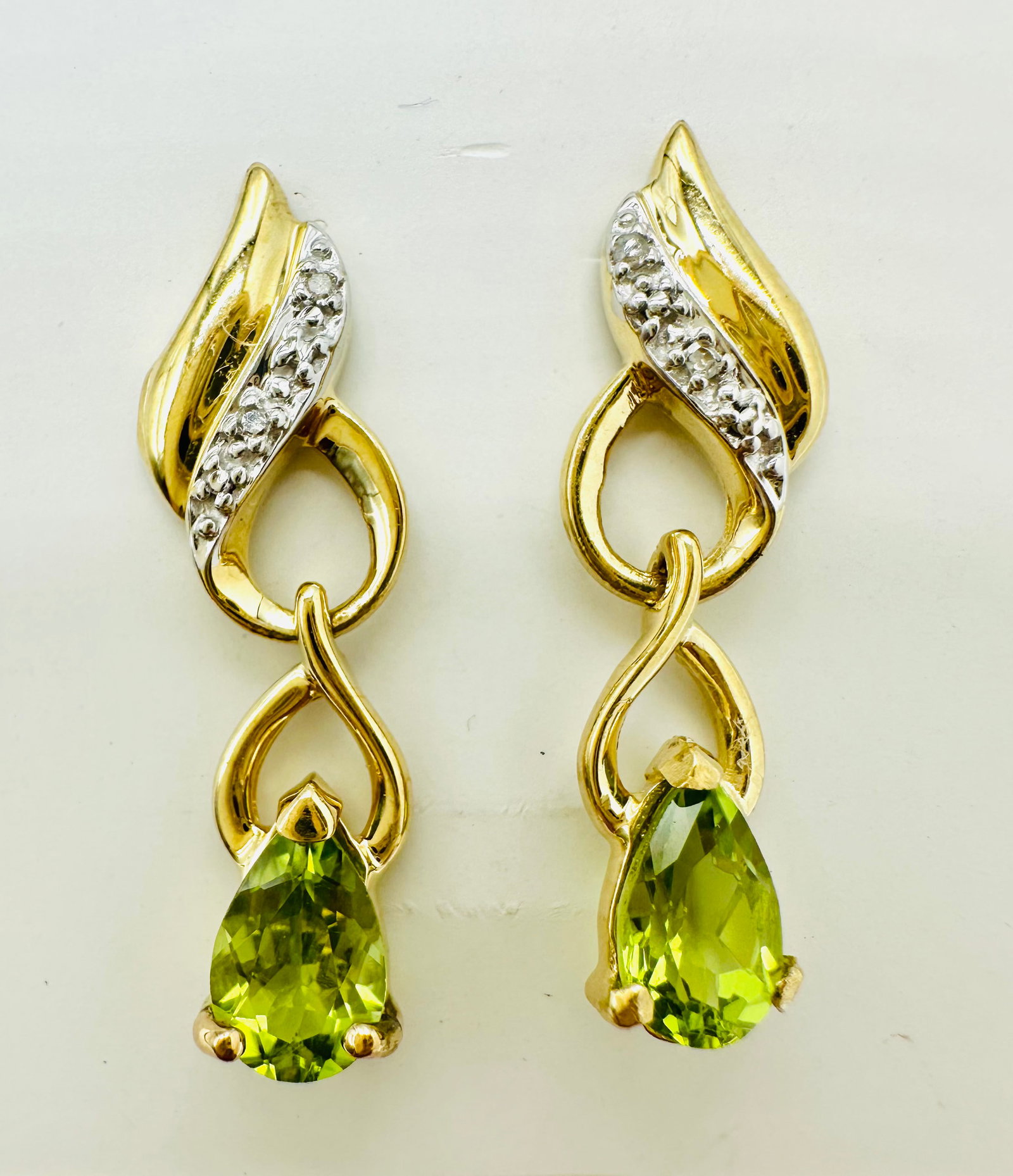 14KT Yellow Gold,Pair of Natural Diamond and Peridot drops Earrings # 2781: # 2781 14KT Yellow Gold,Pair of Natural Diamond and Peridot drops Earrings 4 pieces diamond 2 pieces pear shaped peridot Post back Earrings Weight: 3.20 grams(t.w.) Earrings size: 29 mm x 7.5 mm