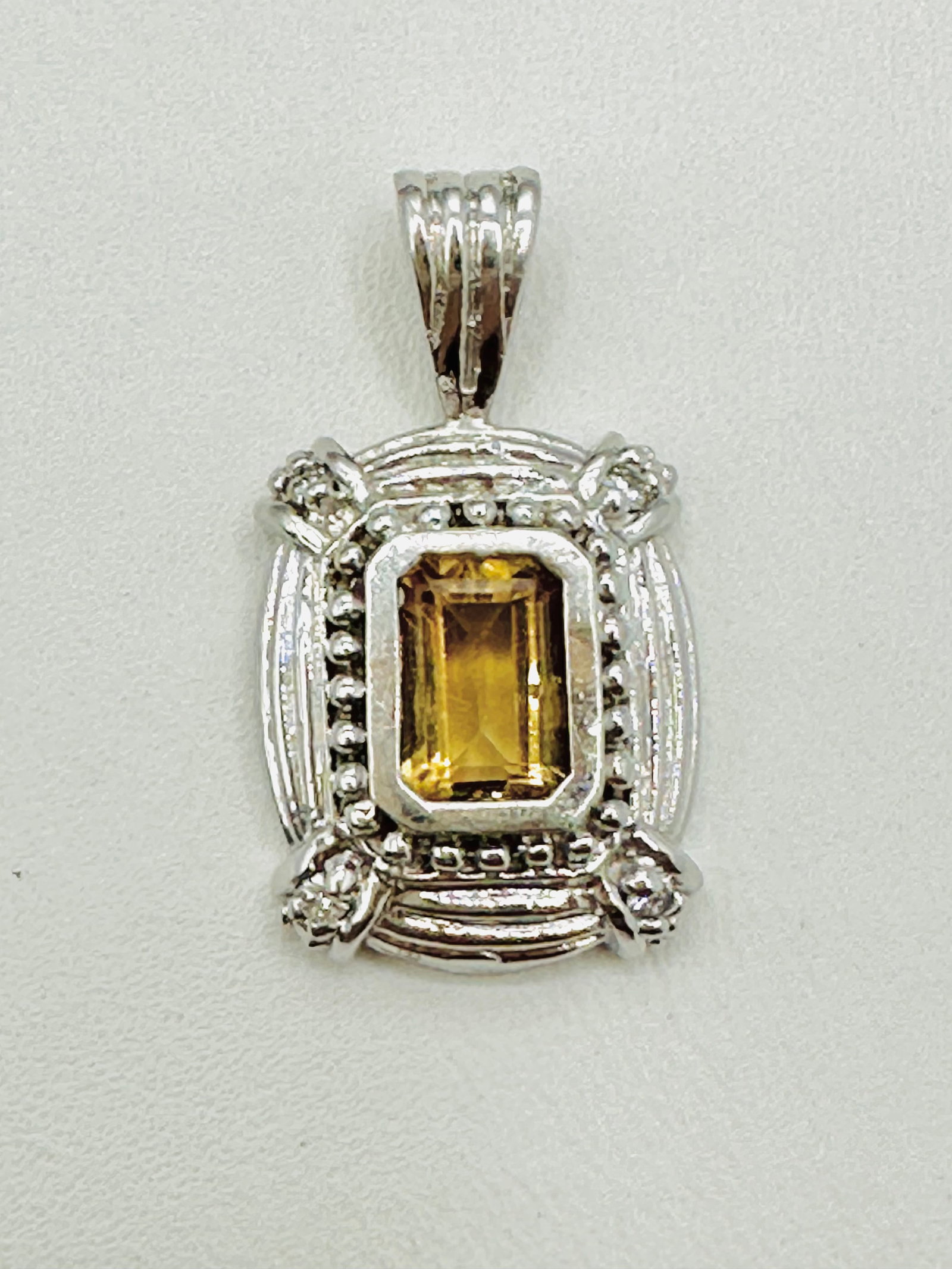 14KT White Gold, Yellow Topaz and Diamond Pendant # 2782: # 2782 14KT White Gold, Yellow Topaz and Diamond Pendant 1 piece yellow topaz 4 pieces diamond Pendant Weight: 3.0 grams (t.w.) Pendant size: 22.5 mm X 12 mm