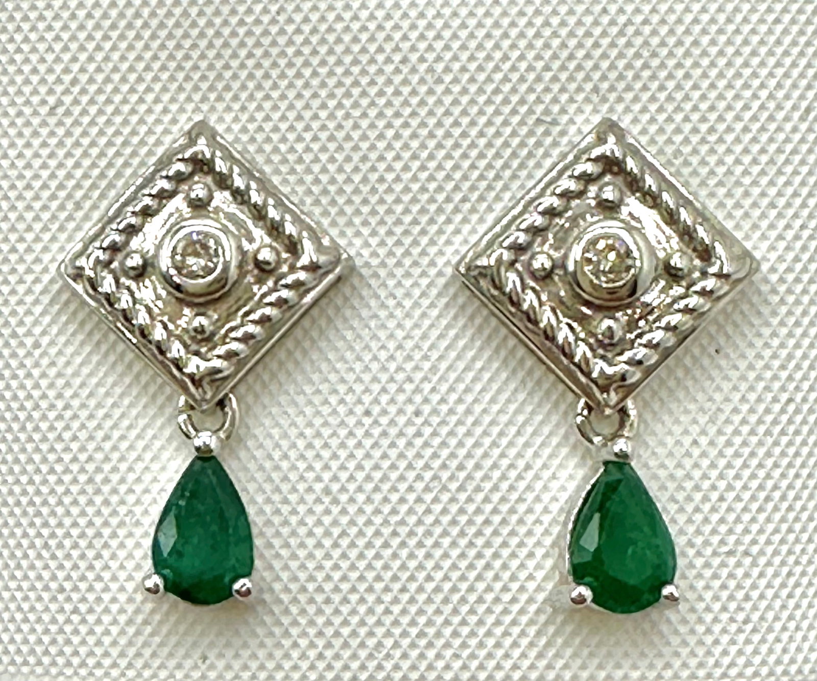 14KT White Gold,Pair of Natural Diamond and Emerald drops Earrings # 2783: # 2783 14KT White Gold,Pair of Natural Diamond and Emerald drops Earrings 2 pieces diamond 0.06 carat(t.w.) 2 pieces pear shaped emerald 0.65 carat (t.w.) Post back Earrings Weight: 3.0 grams(t.w.) Ea