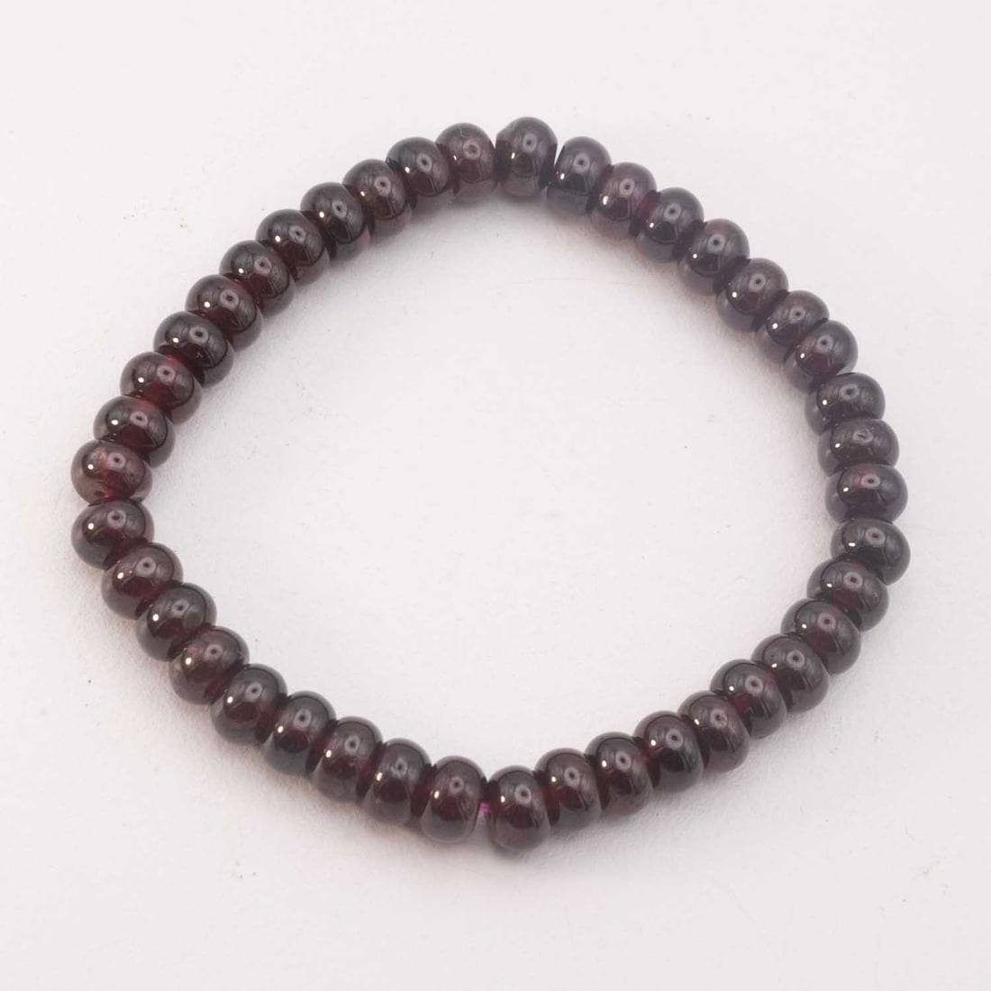 Deep Red Natural Garnet Rondelle Bead Stretch Bracelet: Medium: Natural Garnet Size: 0.3x0.2 inches Age/Detail: Deep Red Condition: great overall, check photo for condition reference. Provenance: Please view all the photos as they are part of the condition