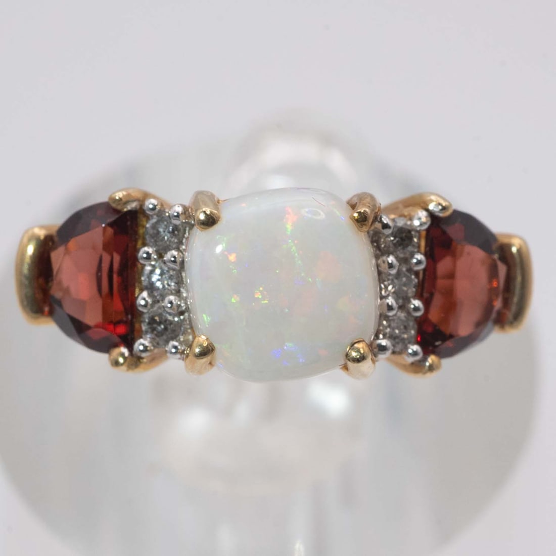 14k Gold Opal And Garnet Ring: Medium: Opal And Garnet Size: US7, 4gram Age/Detail: 14k Gold Condition: great overall, check photo for condition reference. Provenance: Collection from Estate in Williamsburg Please view all the phot