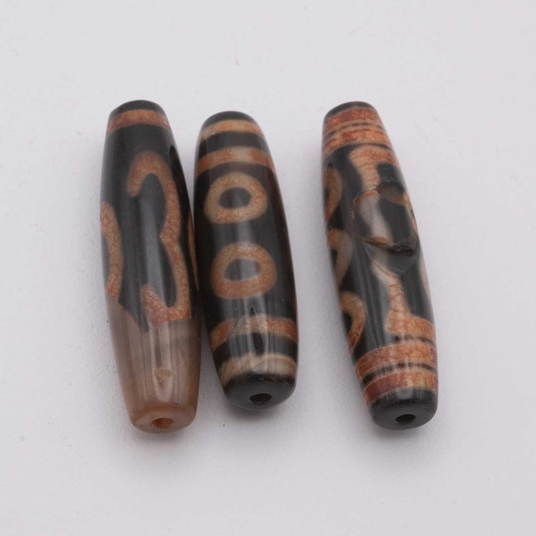 Lot Of 3 Chinese Tibetan Agate Dzi Beads: Medium: Agate Size: 2x0.5 inches Age/Detail: Lot Of 3 Chinese Tibetan Condition: great overall, check photo for condition reference. Provenance: Collection from Estate in Williamsburg Please view all 
