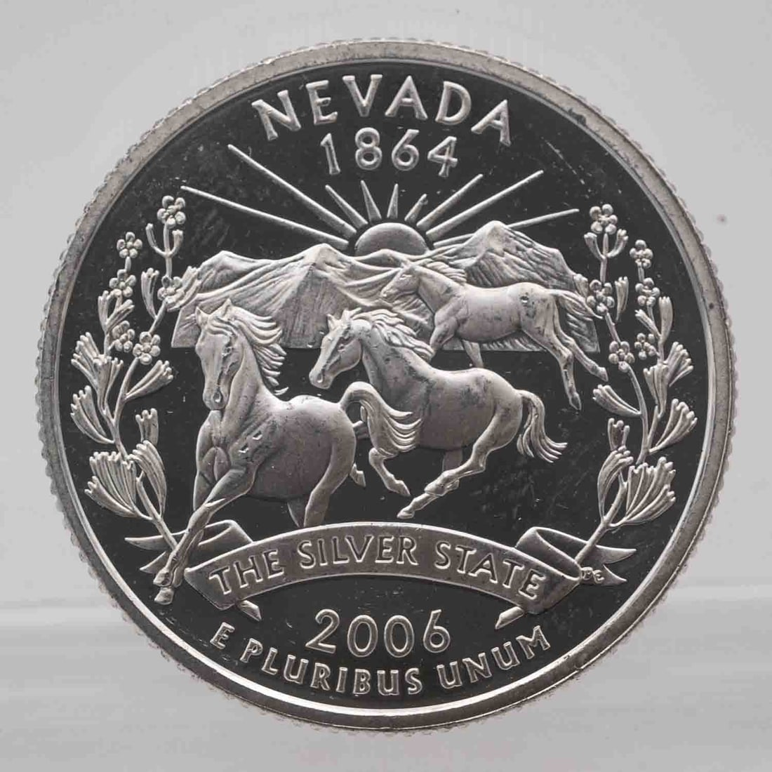 2006 American Proof Silver Quarter Nevada: MLC01175 Provenance: Acquired from reputable coin dealers. Subject: American Proof Silver Quarter Nevada Medium: 900 Silver, approx 0.18 ozt Year: 2006 Condition: MS/AU+, Proof Note, multiple availabl