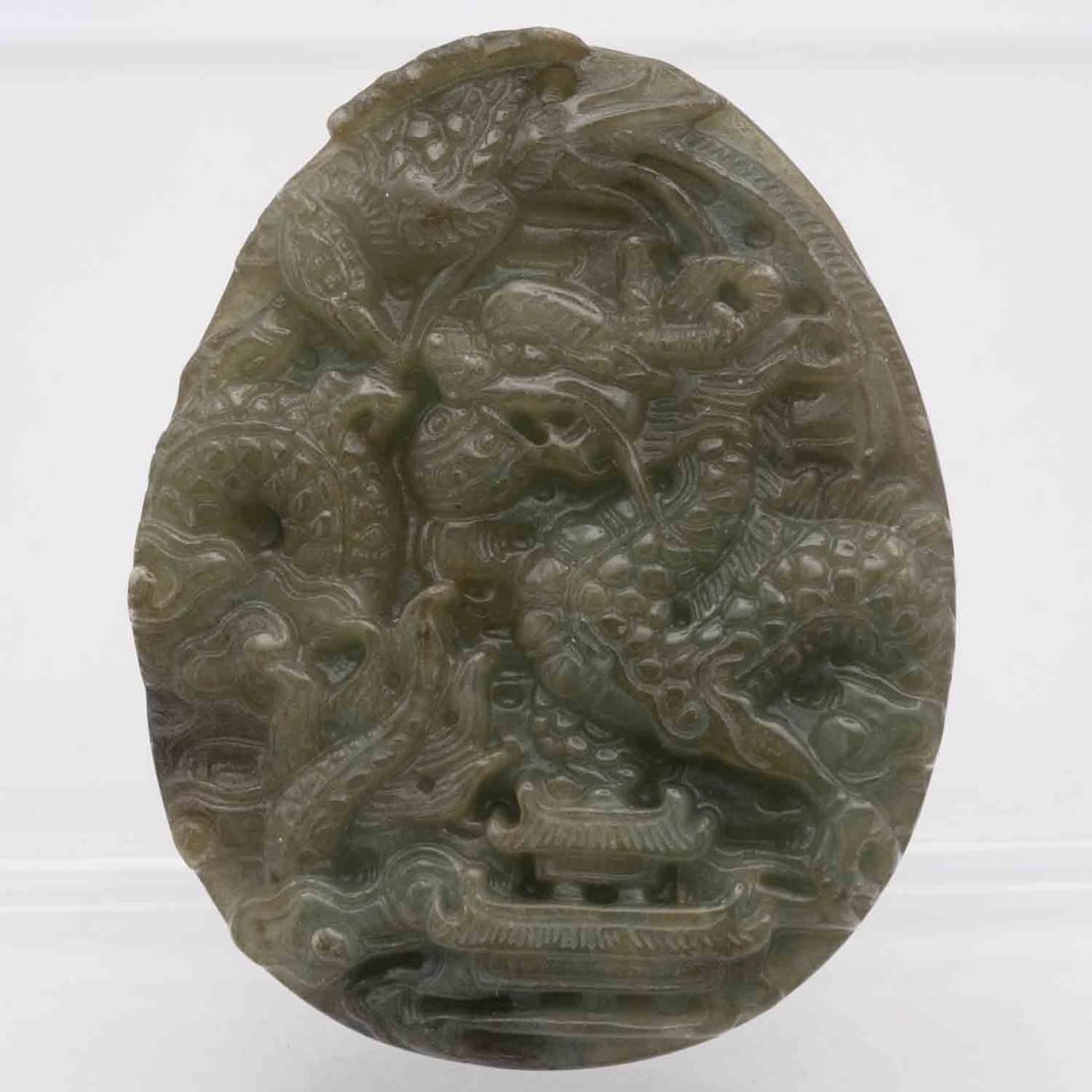 Chinese Carved Natural Green Jadeite Dragon Pendant: Medium: Natural Green Jadeite Size: 2.4x1.8x0.4 inches Age/Detail: Chinese Carved Condition: great overall, check photo for condition reference. Provenance: Collection from Estate in Tribecca Please v