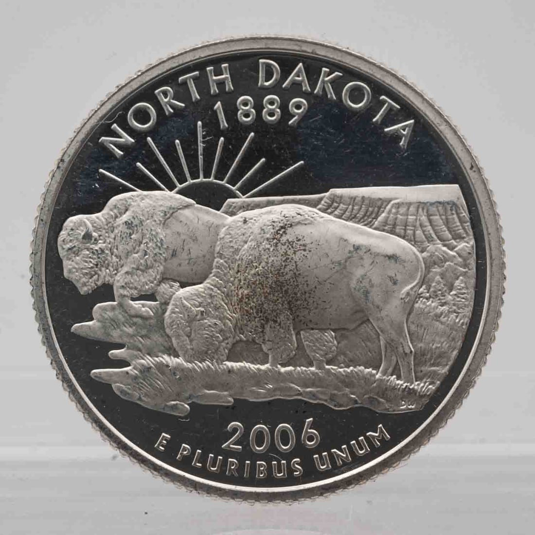 2006 American Proof Silver Quarter North Dakota: MLC01169 Provenance: Acquired from reputable coin dealers. Subject: American Proof Silver Quarter North Dakota Medium: 900 Silver, approx 0.18 ozt Year: 2006 Condition: MS/AU+, Proof Note, multiple av