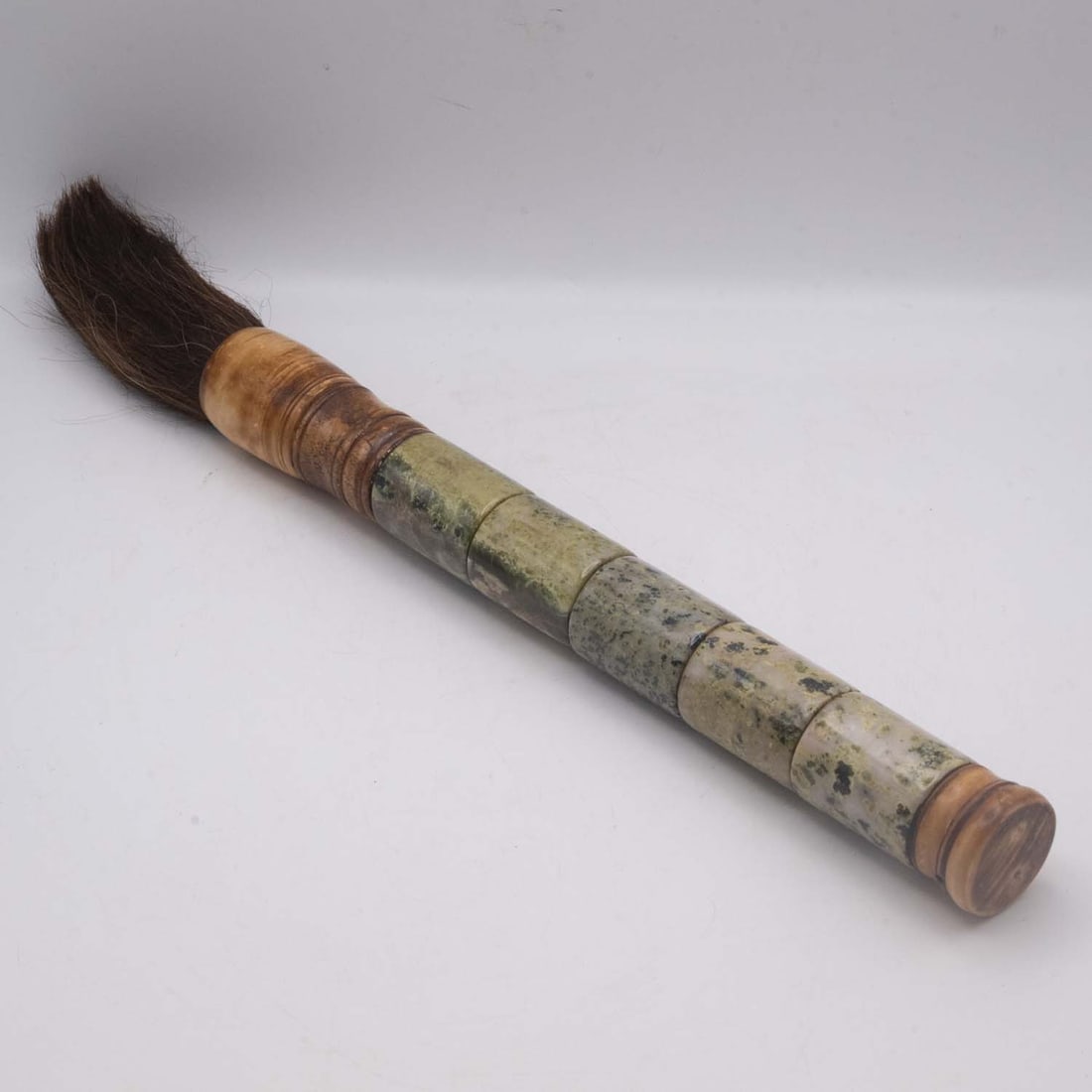 Vintage Chinese Mottled Stone Handle Calligraphy Brush: Medium: Mottled Stone HandleSize: 1.5x1.5x17 inchesAge/Detail: Vintage ChineseCondition: great overall, check photo for condition reference.Provenance:Please view all the photos as they are part of th