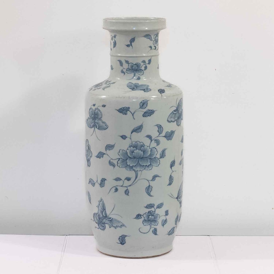 Antique Chinese Qing Blue & White Porcelain Butterfly Peony Rouleau Vase: Medium: Blue & White PorcelainSize: 7.5x7.5x18.5 inchesAge/Detail: Antique Chinese QingCondition: great overall, check photo for condition reference.Good antique condition overall. Visible surface wea