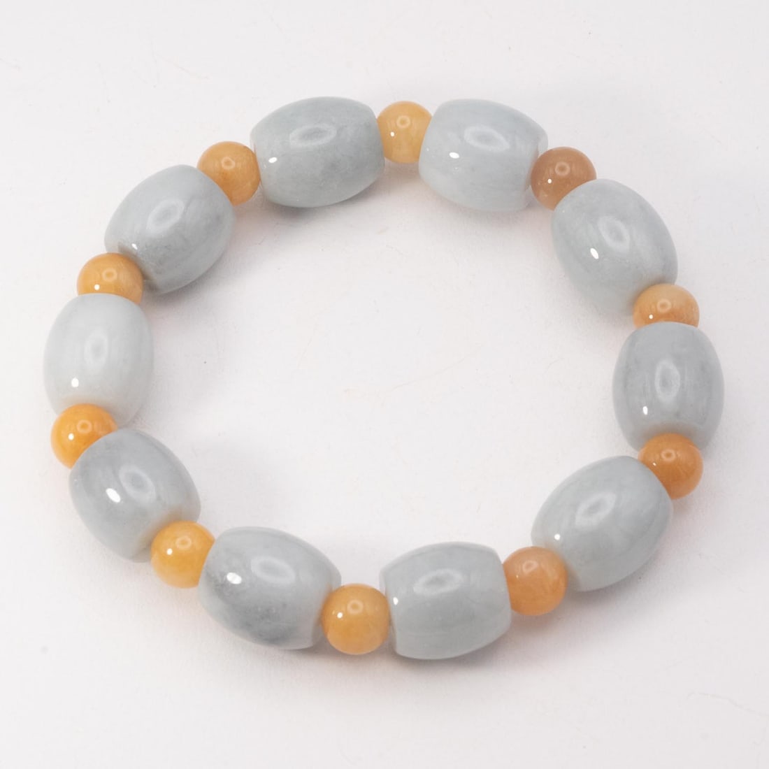 Chinese Carved Gray & Yellow Jadeite Bead Bracelet: Medium: Gray & Yellow JadeiteSize: 12.8x14 mmAge/Detail: Chinese CarvedCondition: great overall, check photo for condition reference.Provenance:Please view all the photos as they are part of the condi