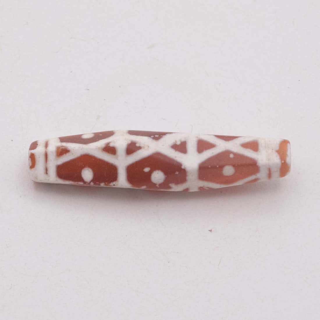 Burmese Pyu-Style Etched Carnelian Geometric Talisman Bead: Medium: Etched CarnelianSize: 1.5x0.4 inchesAge/Detail: Burmese Pyu-StyleCondition: great overall, check photo for condition reference.Provenance:Please view all the photos as they are part of the con