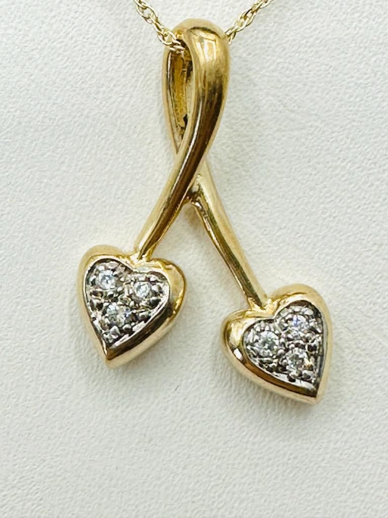 14KT Yellow Gold Natural Diamond Double Heart Pendant and Chain #2012: # 2012 14KT Yellow Gold Natural Diamond Double Heart Pendant and Chain 6 pcs diamond 0.10 carat (t.w.) 18” box chain with spring ring clasp closure Pendant and Chain Weight: 2.50 grams Pendant: 