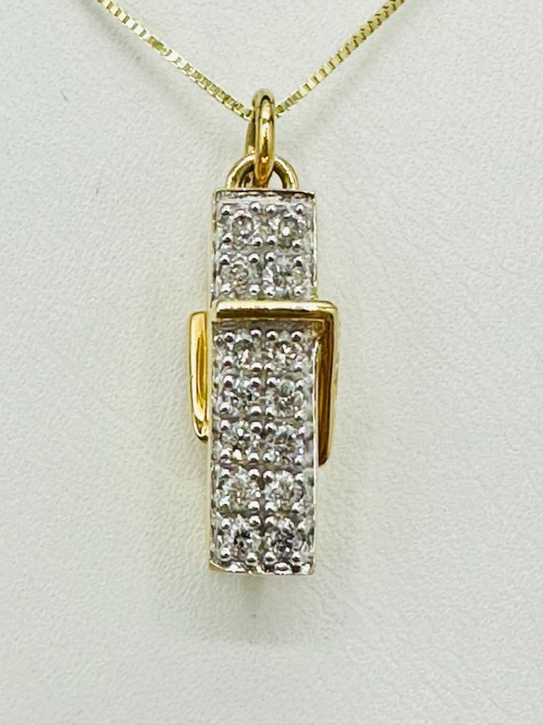 14KT Yellow Gold Natural Diamond Clip Pendant and Chain # 2095: # 2095 14KT Yellow Gold Natural Diamond Clip Pendant and Chain 14 pieces diamond 0.30 carat(t.w.) 18” box chain with spring ring clasp closure Pendant and Chain Weight: 5.10 grams Pendant: 24 mm