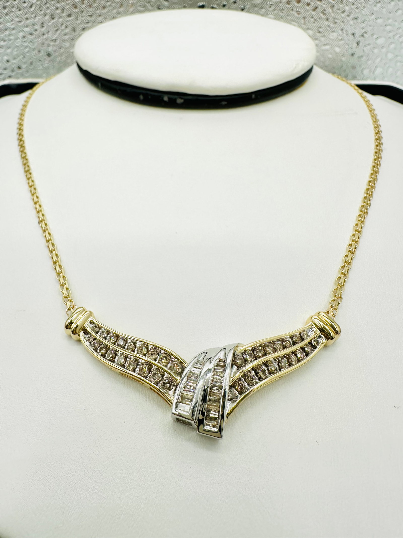Natural Diamond Necklace, Yellow and White Gold # 2669: # 2669 Natural Diamond Necklace, Yellow and White Gold 56 pieces round and baguette diamond 1.38 carat( t.w.) Lobster lock clasp closure Weight: 9.2 grams (t.w.) 18”