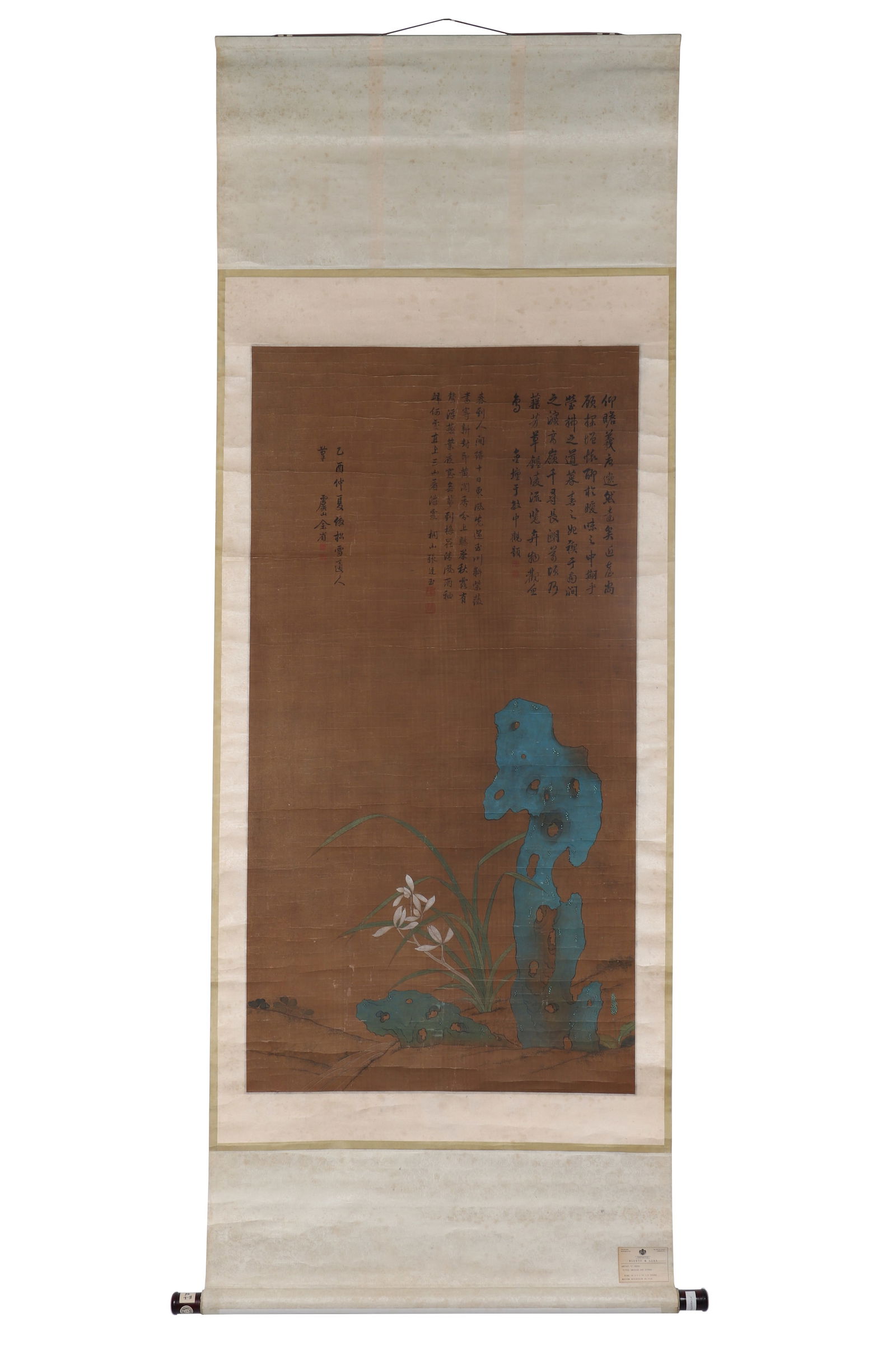 A Chinese Floral Painting, Signed by Yu Sheng: A Chinese floral painting, signed by Yu Sheng, drawing orchids and stones on silk in color. Hanging scroll. There is an ancient label from "BLUETT & SONS" on the painting, and on the shaft head, there