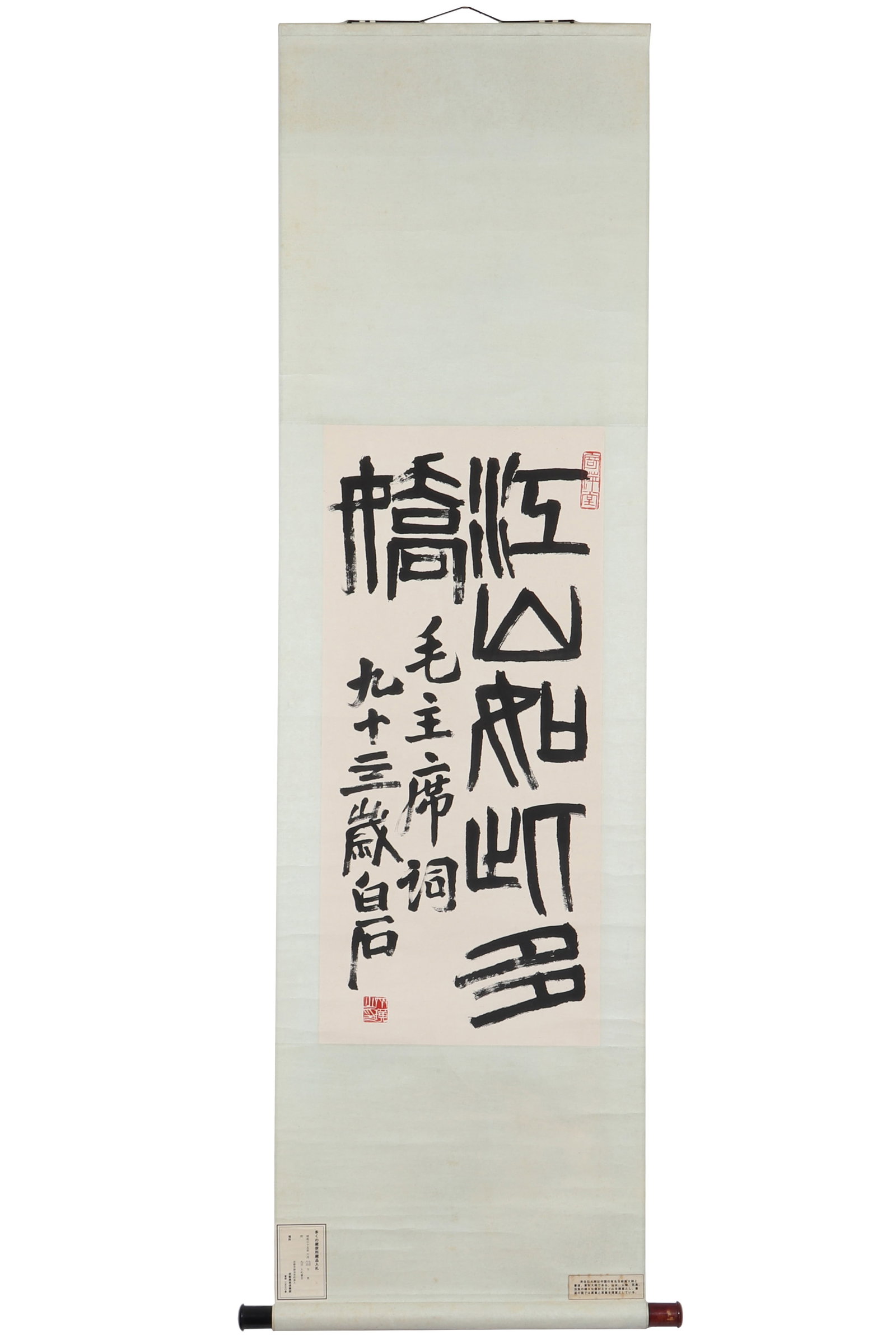 A Piece of Chinese Calligraphy, Signed by Qi Baishi: A piece of Chinese calligraphy, signed by Qi Baishi, featuring two seals, written in ink on paper. There is an introduction and a label at the bottom, and a label at the top of the back. This artwork