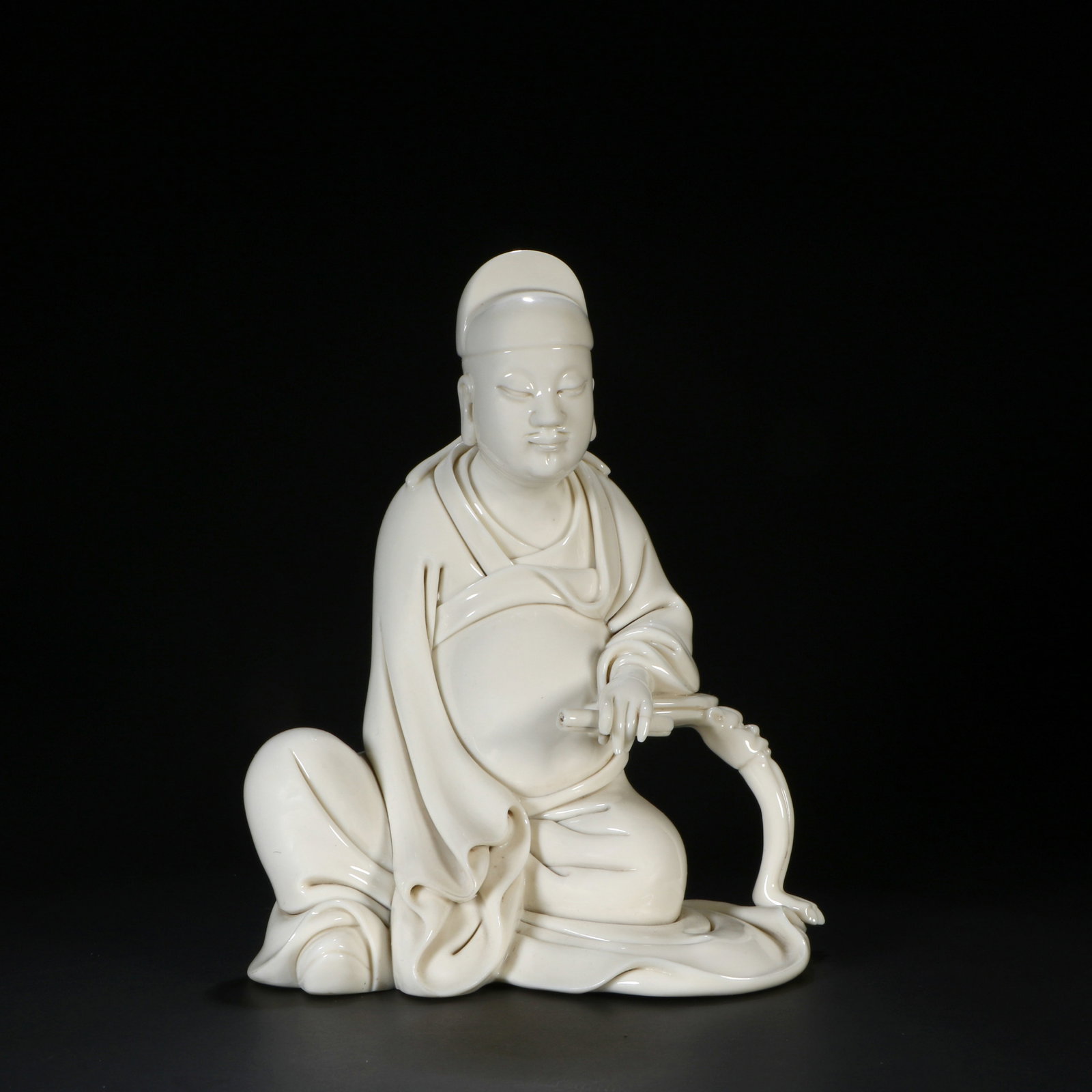 A Dehua white porcelain figurine: Height 17.5 cm, Width 12.2 cm, Thickness 8 cm