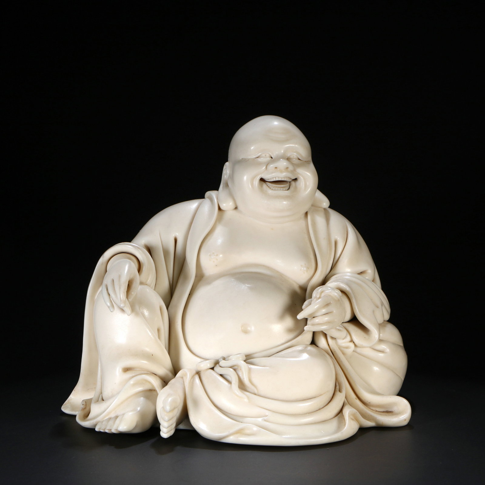 A Dehua white porcelain Maitreya Buddha statue: Height 16cm, Width 18cm, Thickness 15cm