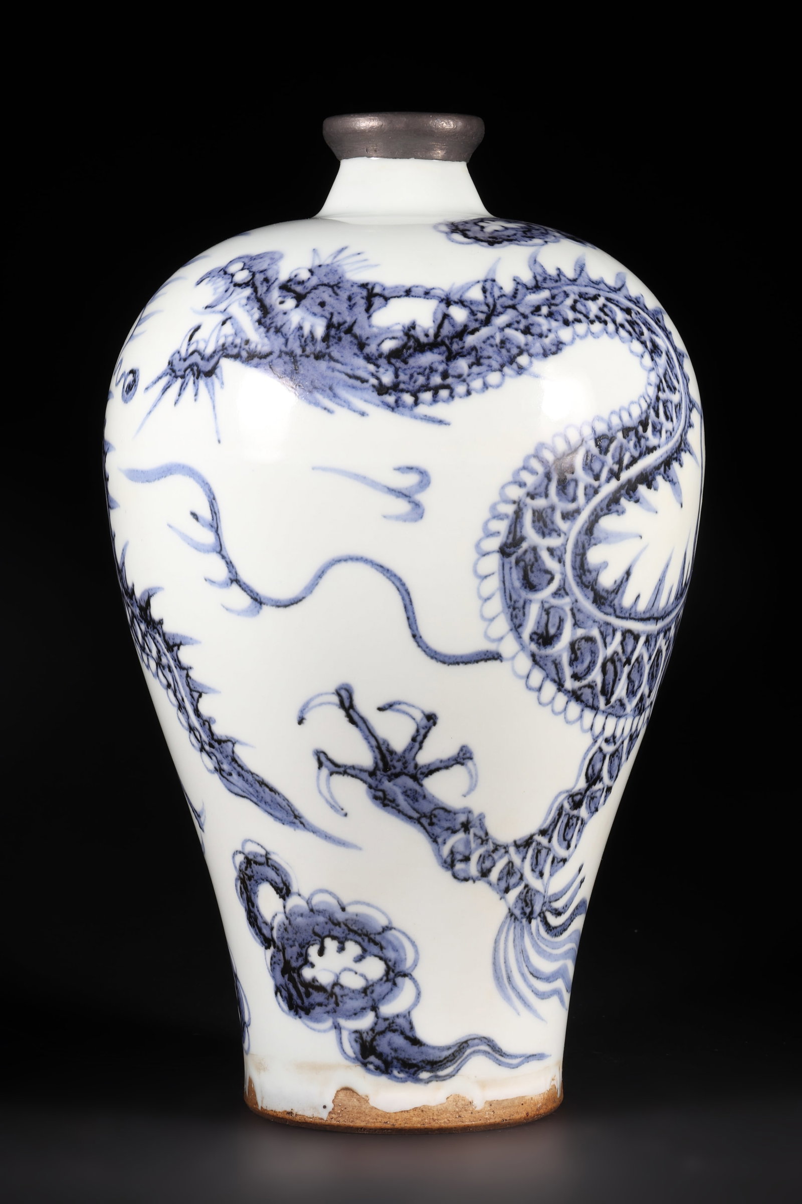A Blue and White Porcelain Vase: A blue and white porcelain vase with a dragon pattern on the body and tin wrapped around the neck. H: 26cm D: 15cm (Max)