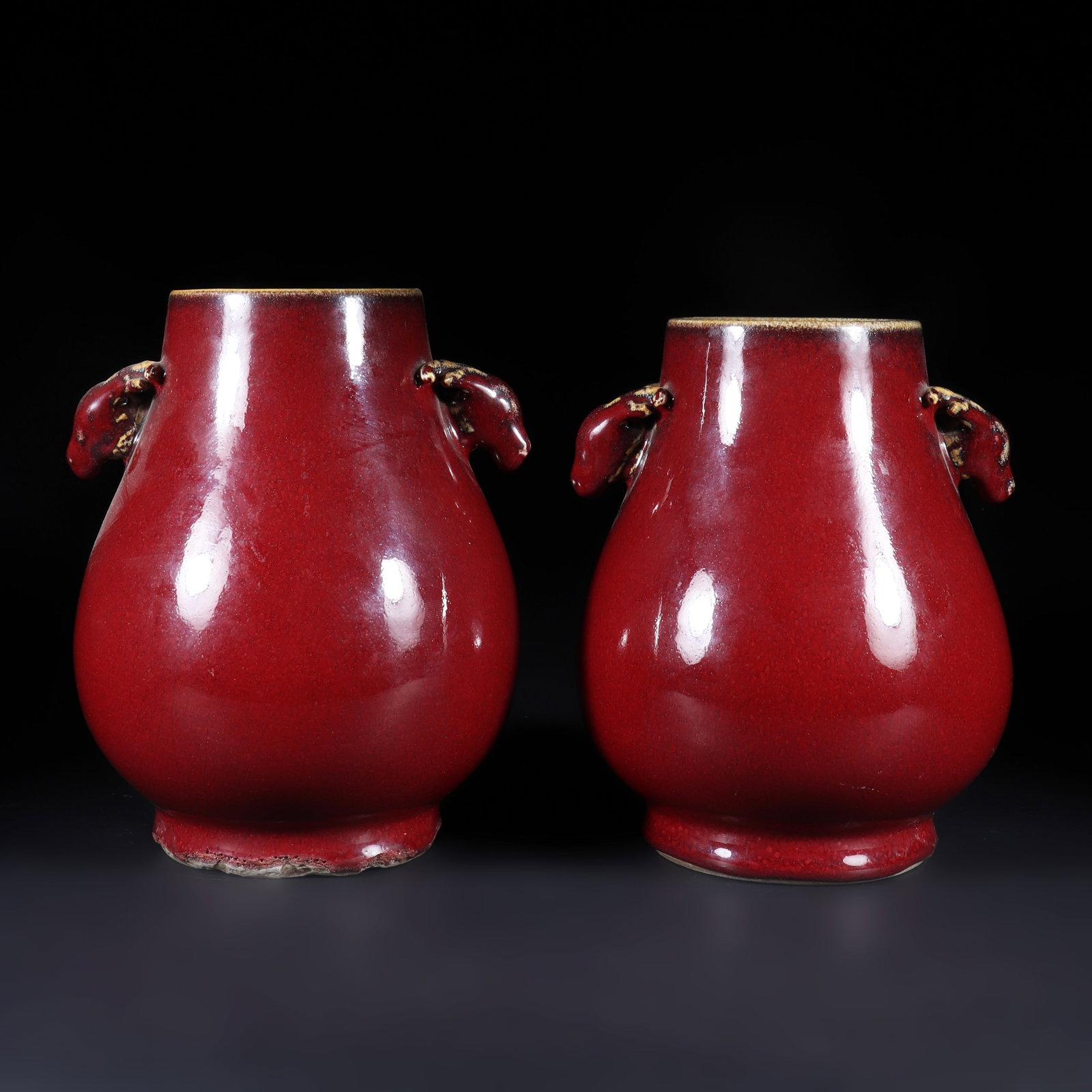 A Pair of Kiln Turned Red Glazed Bottles: A pair of kiln turned red glazed bottles with two deer head shaped ears on the bottle body. H: 26.5cm W: 13cm, H: 27cm W: 13cm (Max)