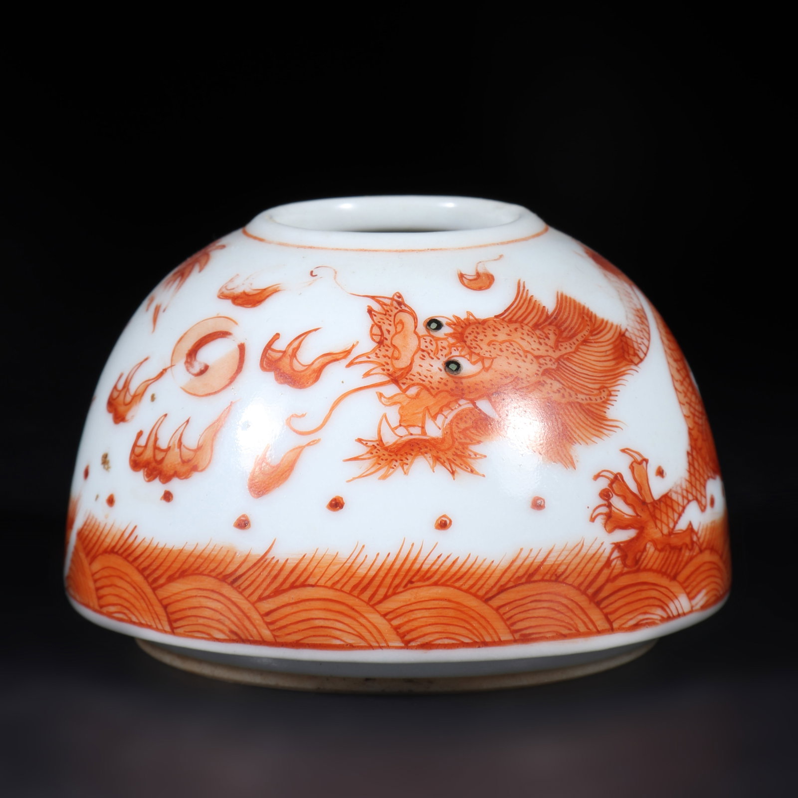 A Alum Red Porcelain Wa1ter Basin: A alum red porcelain water basin with a dragon pattern on it. H: 4cm D: 6.5cm (Max)