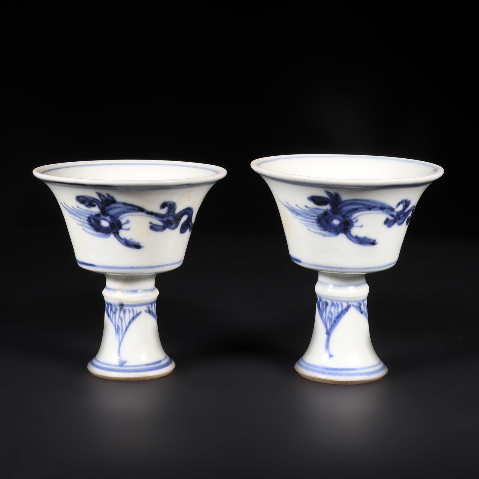 A Pair of Blue and White Porcelain High Footed Cups: A pair of blue and white porcelain high footed cups with dragon patterns on the cup body. H: 7.5cm D: 7cm X2 (Max)