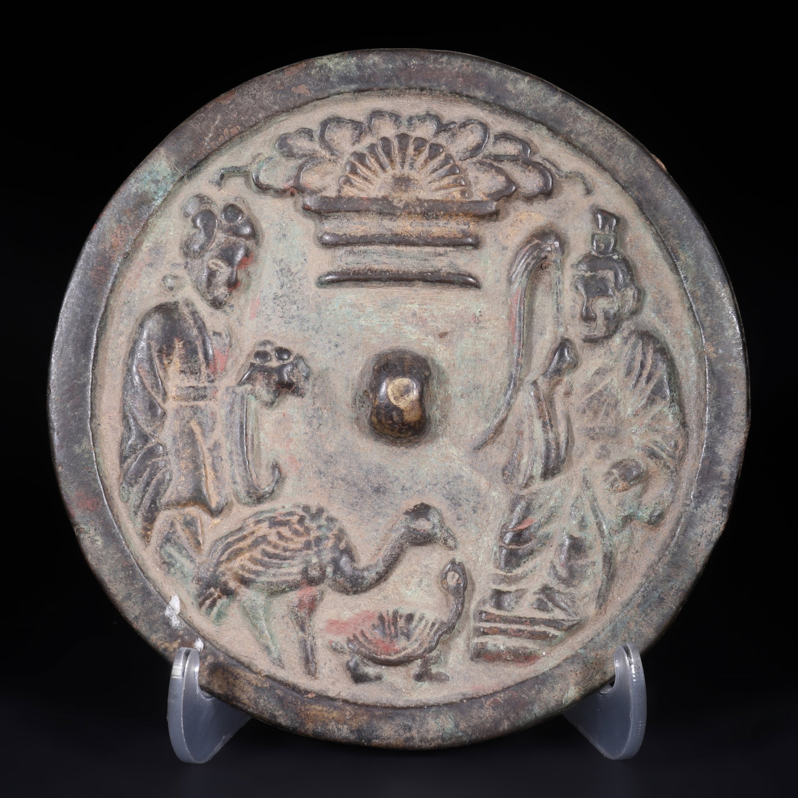 An Ancient Bronze Mirror: An ancient bronze mirror with patterns of immortals, turtles, and cranes engraved on the back, symbolizing longevity. D: 12.5cm (Max)