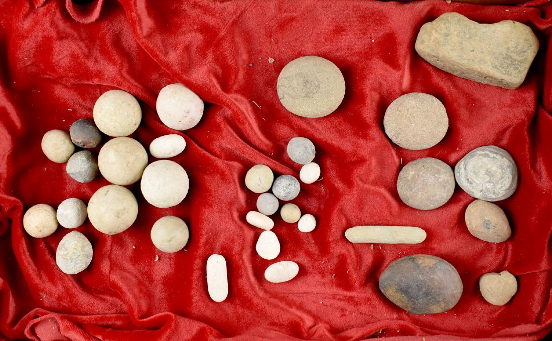 Game Balls and other assorted relics: Lot of approx 28+ Game Stones/Balls from the Les Speer Collection.