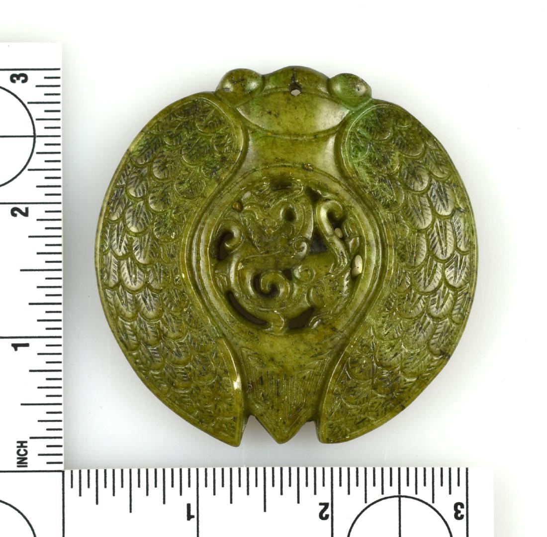 2 13/16" Chinese Carved Cicada with Dragon: Unusual example of a cicada with feathered wings, with a 'heart' of a dragon. Green jade-like stone. Exact age unknown.