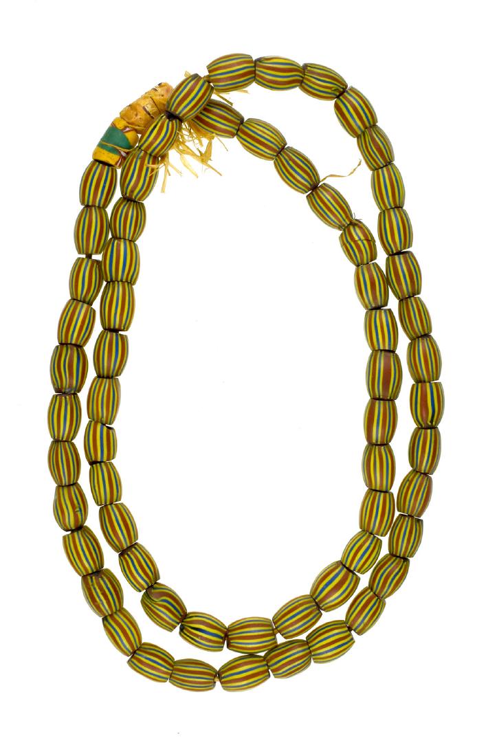 30" Strand of Striped Oval Beads: Nice strand of yellow, blue, red striped beads. Ex - Meyer Collection.