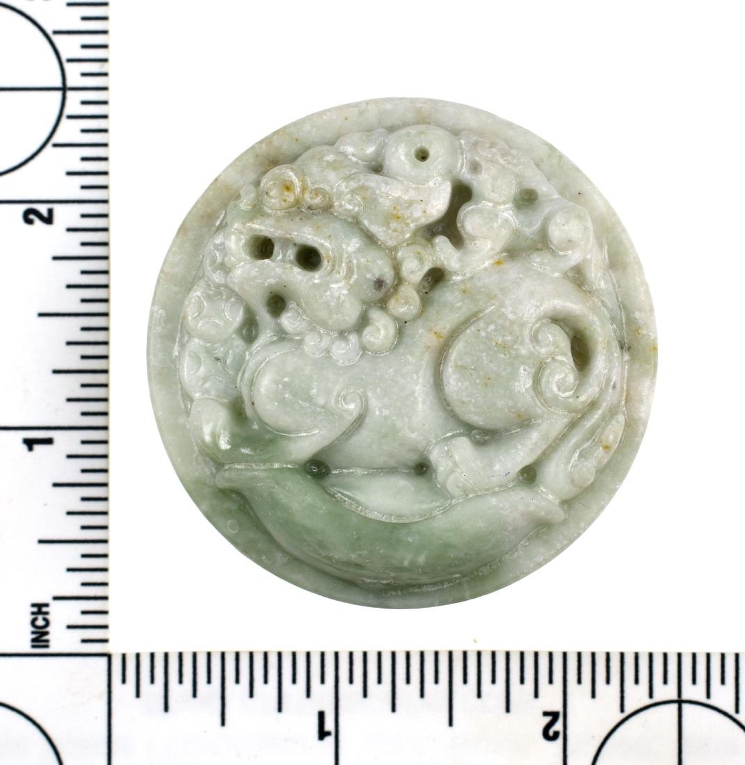 Excellent Chinese Jade Sash Buckle: Beautiful example. 2 1/8" round translucent white and green Jade. Exquisitely depicted 'Dragon on cloud' motif. Classic Ming Dynasty style. Later execution. Mid- 20th Century. Weighs 66 grams.