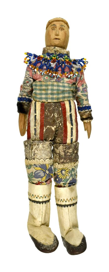 15.5" Greenland Inuit Doll: Superb example with sealskin boots and mittens with fur leggings with cloth anorak. Carved Wooden face. Early 20th Century. Ex - Montgomery County Library Collection.