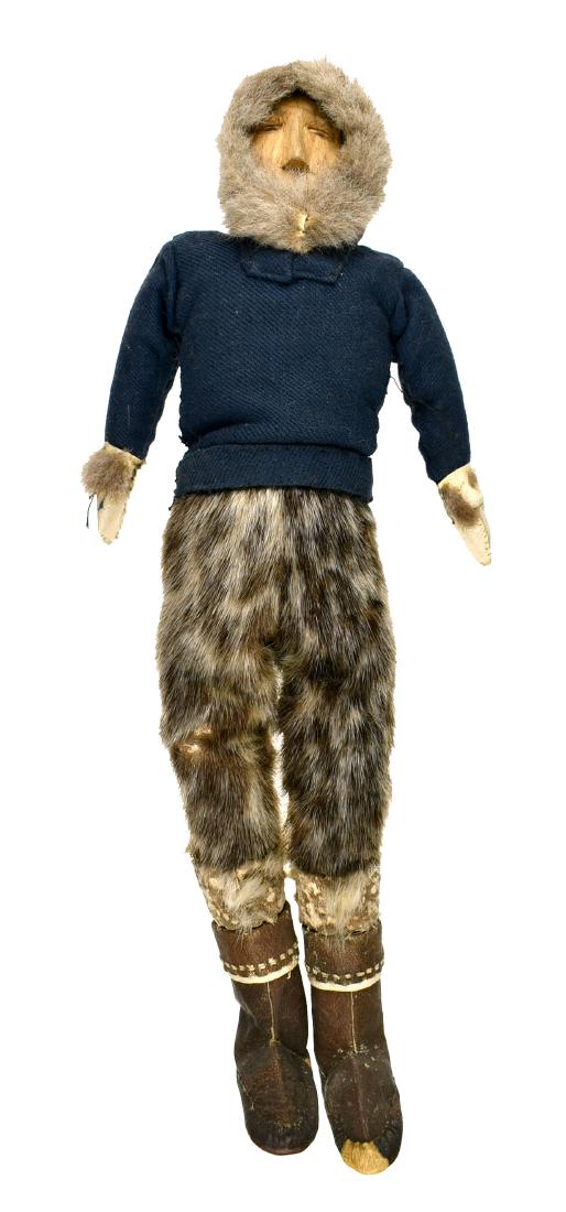 12.25" Greenland Inuit Doll: Superb example with sealskin boots and leggings with cloth top and beads. Carved Wooden face and hands. Early 20th Century. Ex - Montgomery County Library Collection.