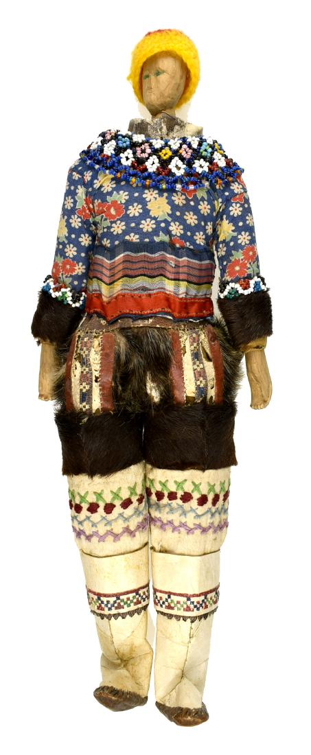 14.5" Greenland Inuit Doll: Superb example with sealskin boots and fur leggings with cloth top. Includes beaded drape and woven hat. Carved Wooden face and hands. Early 20th Century. Ex - Montgomery County Library Collection.