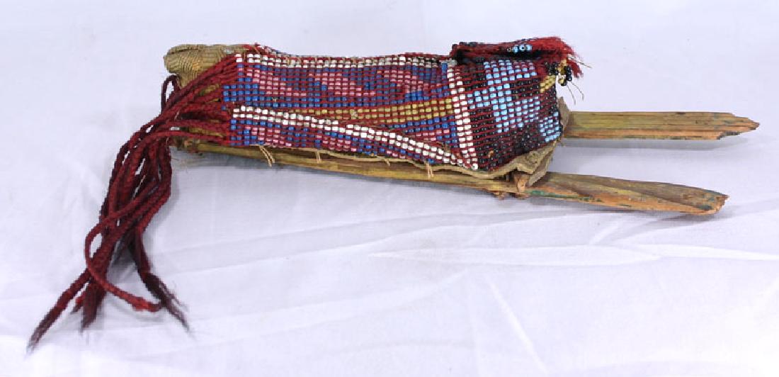Early ca. 1880's Native American Beaded Child's: DESCRIPTION:_x000D_ 6 1/2" beaded 'papoose' section. 14" Overall cradle and doll. Painted wooden backboards. Plains type geometrically beaded papoose section stuffed with unknown material (not dismant
