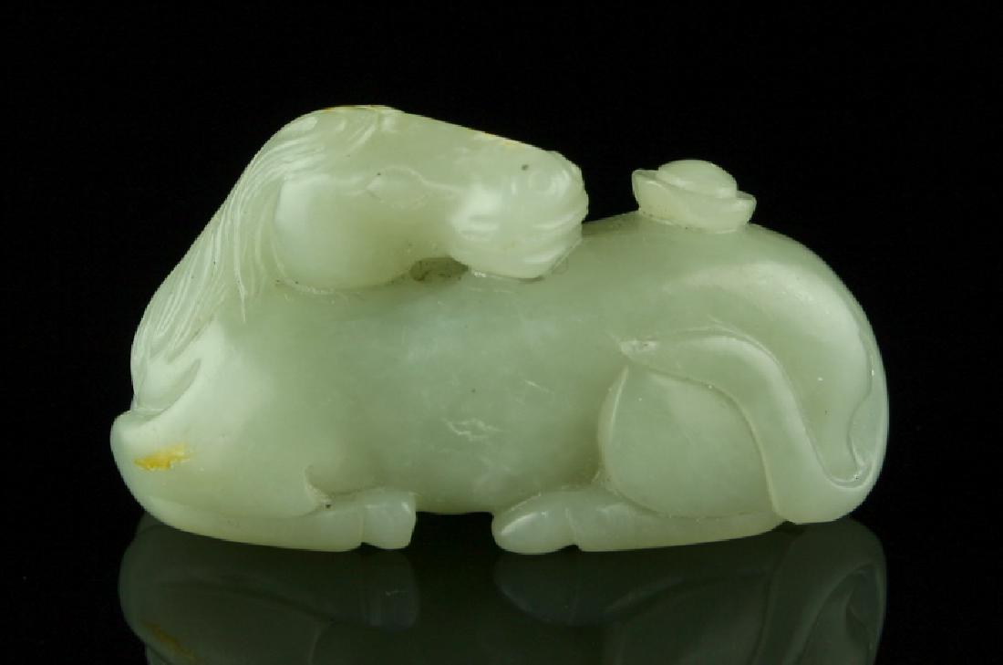 Important Chinese Ming Dynasty Jade Horse Carving: Finely Carved Ming Dynasty (1368-1644 A.D.) Jade Horse. Extra pure light green highly translucent Jade recumbent Horse with an Ingot on its back. Chinese Ingots represent wealth and prosperity. 