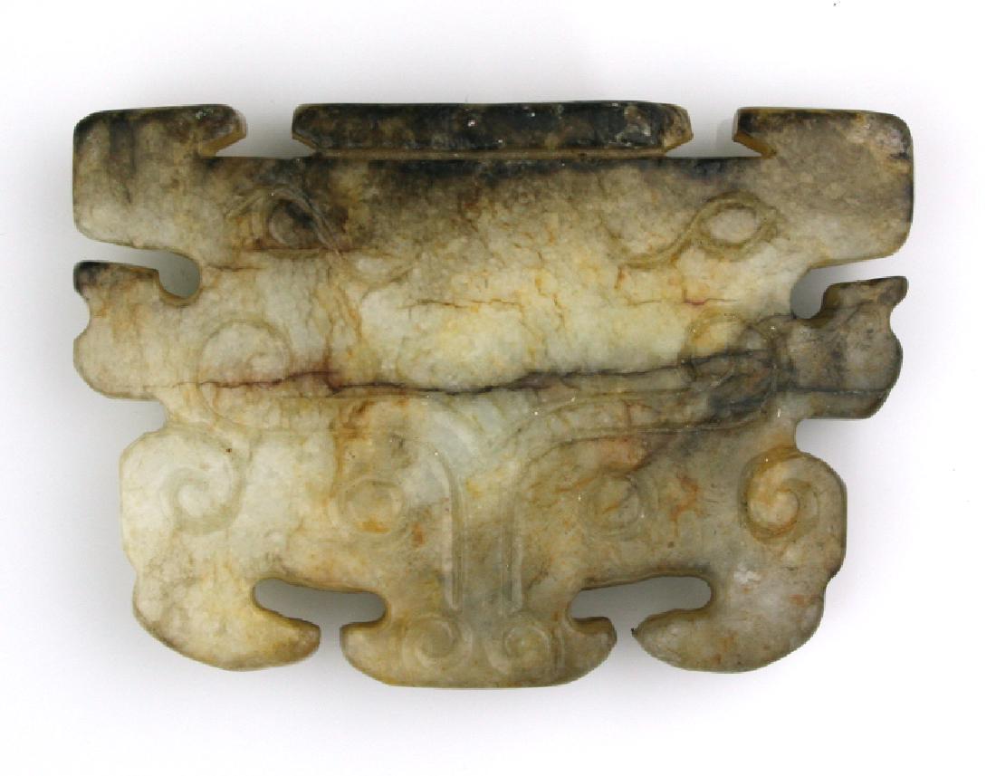 2 5/8" Ancient Chinese Jade Taotie Mask: Expertly carved white and russet Jade Han Dynasty example Taotie mask. Exhibits great differential weathering yet carving still displays as detailed and precise. Highly translucent Jade. Vertically dr