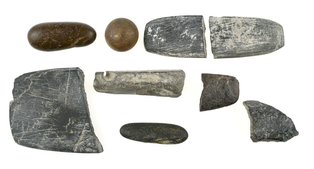 Site Specific Stone Assemblage - Ex- Doc Stewart: One polished steatite pipe remnant. One broken in half pendant with different patination on each piece. One large pendant fragment with grafitti/incising. One small pendant fragment. One long slender