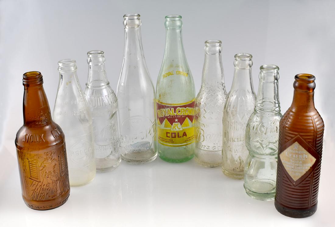 9 Vintage Soda Bottles: Fancy 'Nu-Grape', Brown 'Orange Crush', Hendrickson's Quality Soda Water, Royal Crown Copyright 1936, Drink Barq's It's Good, Pepsi-Cola, Sioux City Sarsaparilla, Indian River Soda Water, Hi-Port.