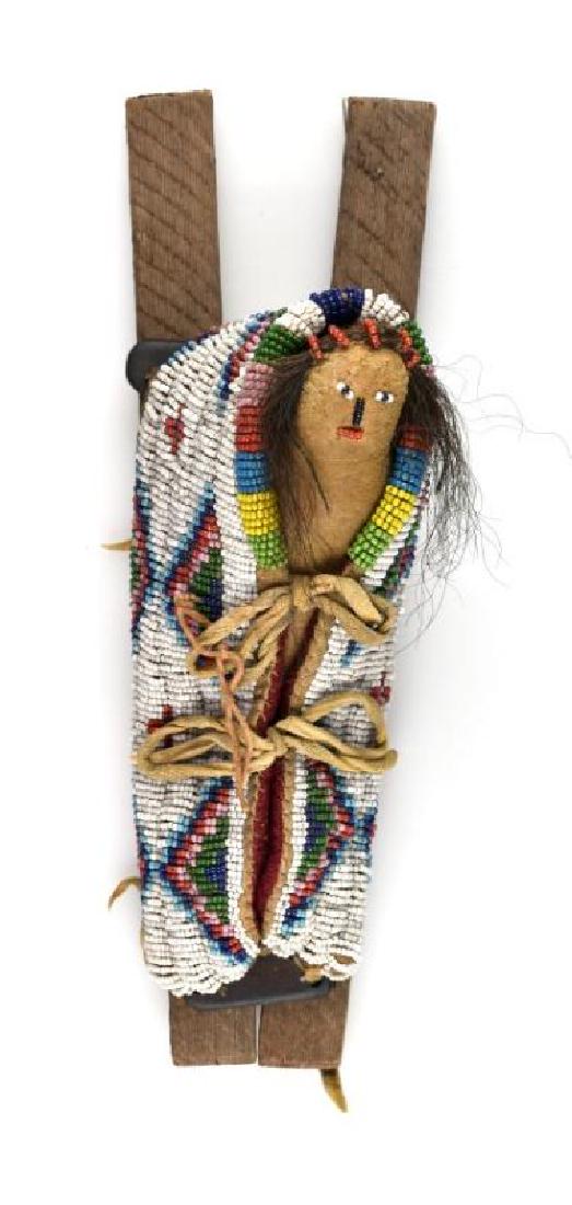 Beaded Plains Indian Cradle & Doll - Ex- Curtis Hill: Super rare Museum Quality Native American piece. Ca. Turn-of-the Century. 10 3/4" overall length. Intricate multi-colored geometric beaded designs on rawhide with red felt/trade cloth interior. Doll h
