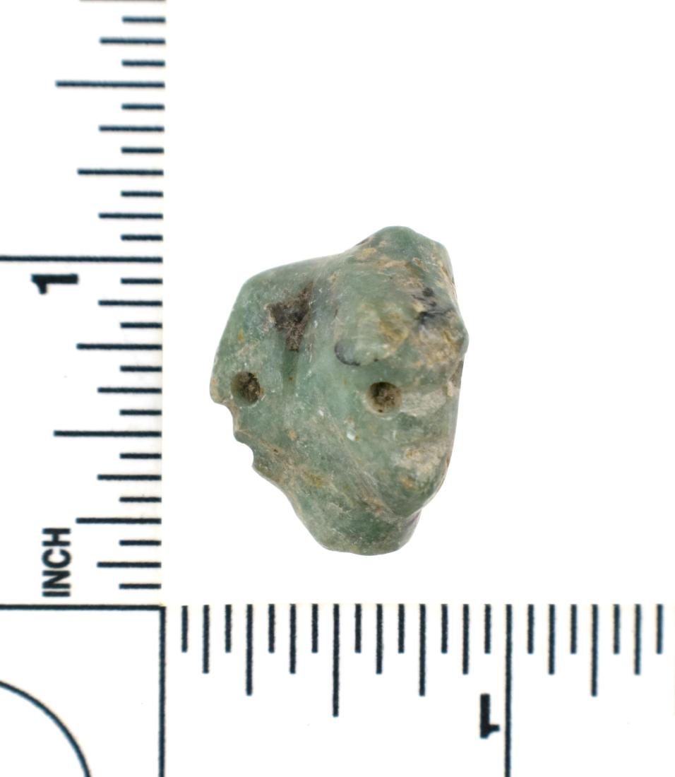 Rare and Fine Mayan Double Face Effigy Bead: Pre-Columbian. Drilled lengthwise for suspension. Probably worn as an earring or drop pendant. Truly a high art example from the Mayan Culture, ca. 600-900 A.D. Greenstone. Rare tribolate shape measur