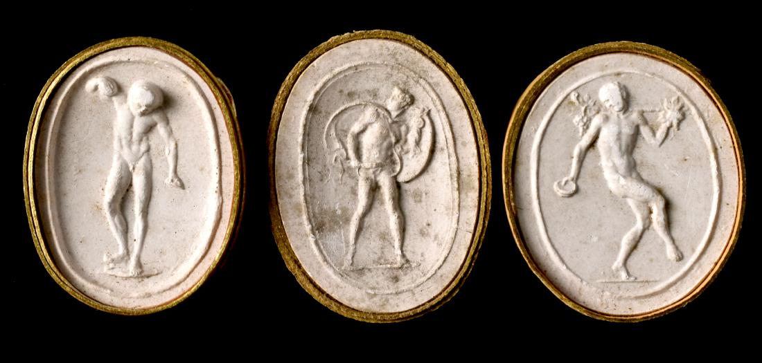3 Grand Tour Plaster Cast Cameos: 19th Century Italian Grand Tour collection of three plaster casts of ancient cameos depicting standing males / Gods. All three bound in original gilt-highlighted paper slips. All three measures right