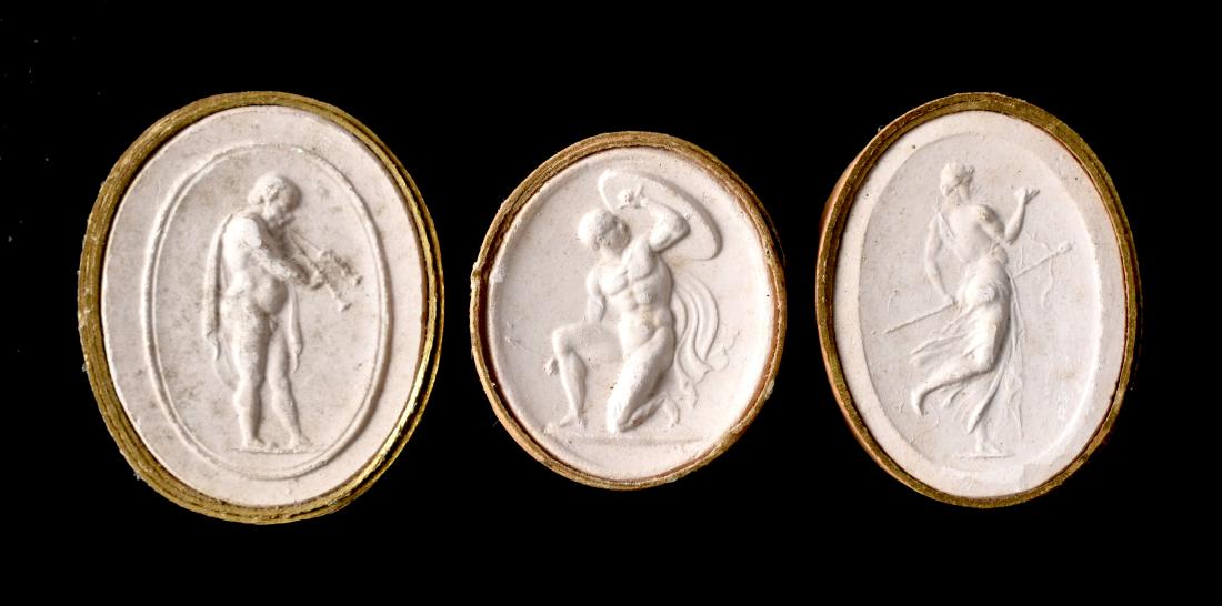 3 Grand Tour Plaster Cast Cameos: 19th Century Italian Grand Tour collection of three plaster casts of ancient cameos depicting standing males. Pan with his flute and two different poses featuring Hercules with shield and spear. All t