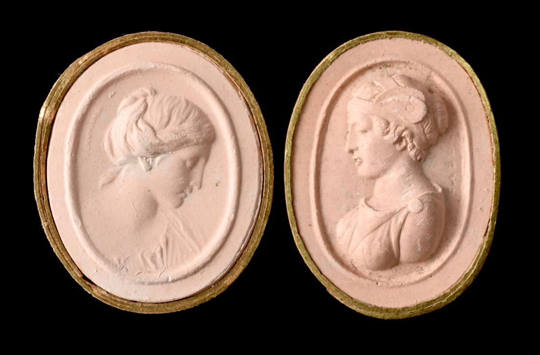 Pair of Grand Tour Plaster Cast Cameos: 19th Century Italian Grand Tour collection of two plaster casts of ancient Roman Goddesses bound in gilt-highlighted paper slips. Both measure 1 1/8". Flawless condition with incredible detail. E