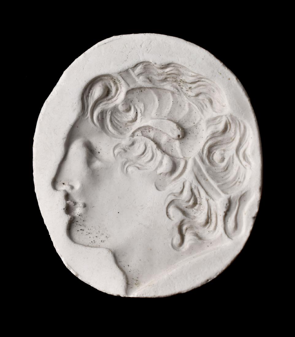 Excellent Intaglio Plaster Cast of Alexander the Great: Late 19th Century. Finely carved profile of Alexander with horn of Ammon in profile similar to coins of him minted in the era. Alexander was depicted with the horns of Ammon as a result of his conques