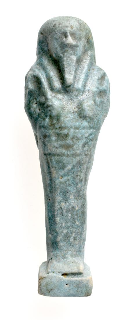 110mm Egyptian Faience Ushabti: Egypt. 26th Dynasty. ca. 662-525 B.C. Nicely detailed large light blue faience Ushabti holding crook and flail in his hands ready to perform the tasks of the recently deceased in the afterlife. 