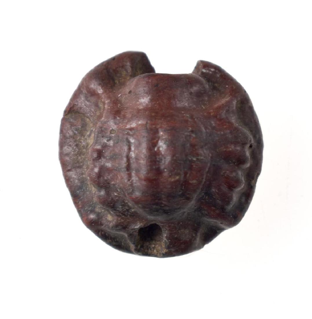 3rd-4th Century Roman Glass Bead: Extremely rare form drilled thru top to bottom for suspension. Made of molded red glass with uncertain motif. Could be a beetle, a spider, a crab, or even a loaf of bread. Actually one expert thought