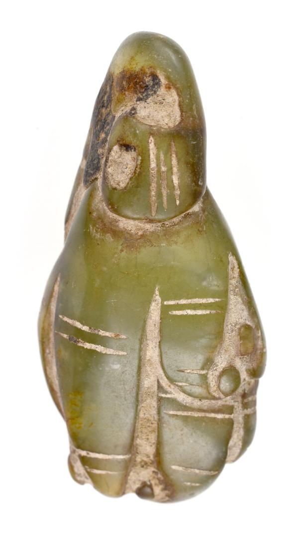Unique 3" Chinese Jade Sculpture: Eccentric/abstract undrilled form appears to be Hongshan era in style. Made of high quality light green highly translucent Nephrite Jade and is highly polished over its entirety. All of the incising i