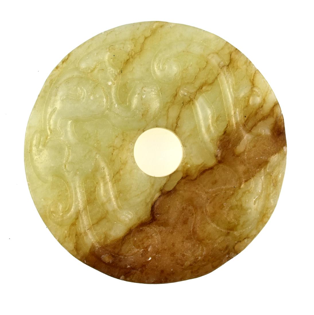 Fine Early 2 1/4" Chinese Jade Bi: Masterfully carved example in translucent green Jade with russet riverring. High relief chilong dragons on one side and dot pattern on the back. Right at 2 1/4" round by 1/4" thick. Displays
